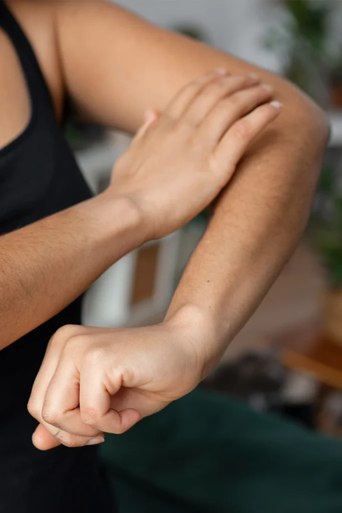 Close Up Woman Touching Arm Pain