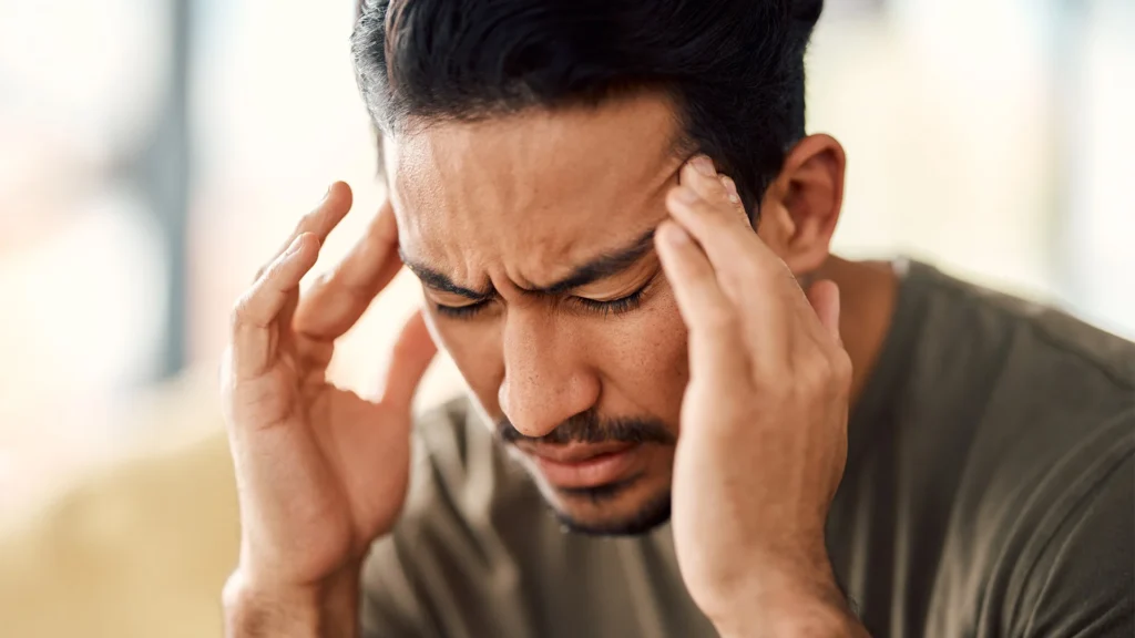 Man Presses His Fingers Against His Temples To Ease Vertigo