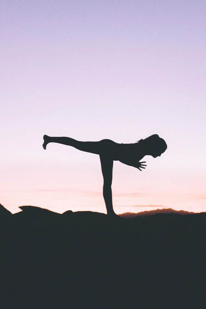 Silhouette Of A Woman Balancing On One Leg